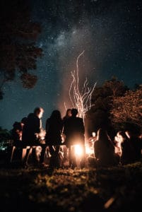 People standing around a bonfire